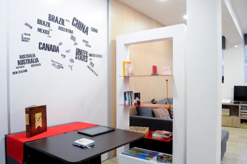 a room with a desk and a table with at Folco Studio Apartment in Piazza Armerina