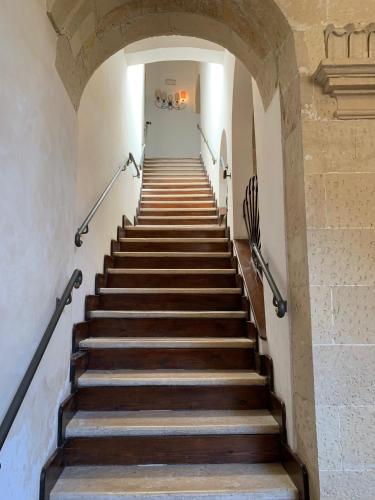 a staircase in a building with wooden steps at Buon Consiglio B&B in Lecce