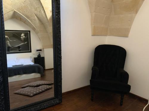 a mirror and a chair in a room at Buon Consiglio B&B in Lecce