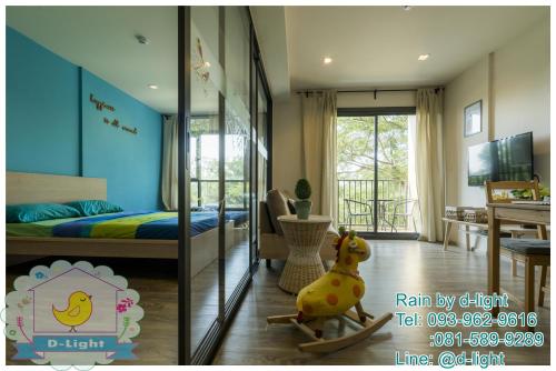 a room with a bedroom with a bed and a desk at Rain Cha-am Hua Hin by D-light in Cha Am