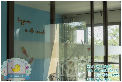 a glass window with a picture of a chicken on it at Rain Cha-am Hua Hin by D-light in Cha Am