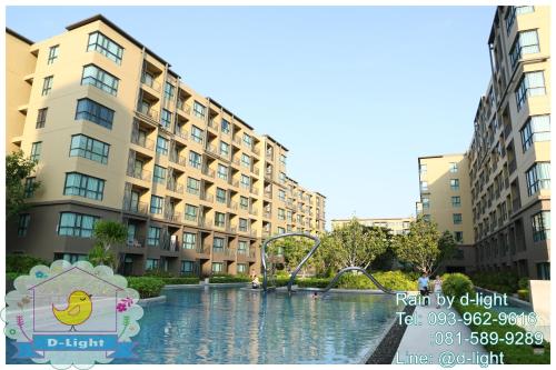 a pool of water in front of some buildings at Rain Cha-am Hua Hin by D-light in Cha Am