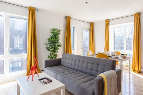 a living room with a couch and a table at Alywin Apartments in Hochelaga in Montréal