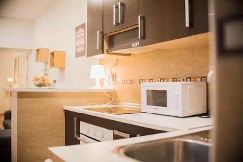 a kitchen with a sink and a microwave at NICE HOME city center in Melilla