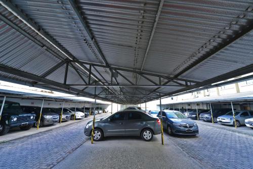 a parking lot with several cars parked in it at Curi Palace Hotel in Pelotas