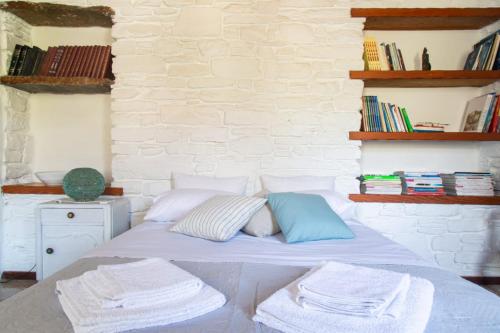 a bedroom with a bed with towels on it at Sun Holiday House in Pisses