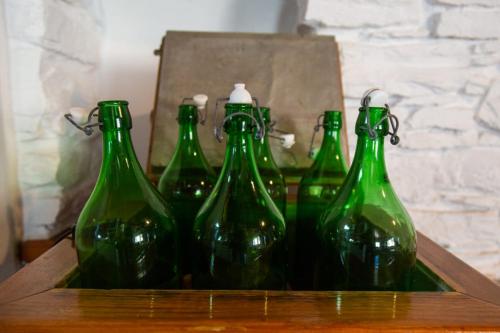 a group of green bottles sitting on a table at Sun Holiday House in Pisses
