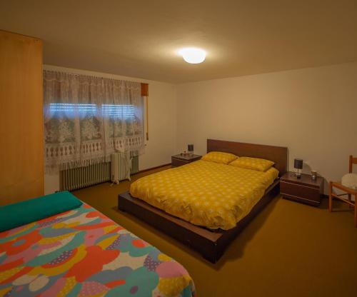 a bedroom with a bed and a window at Casa Fiorellino in Belluno