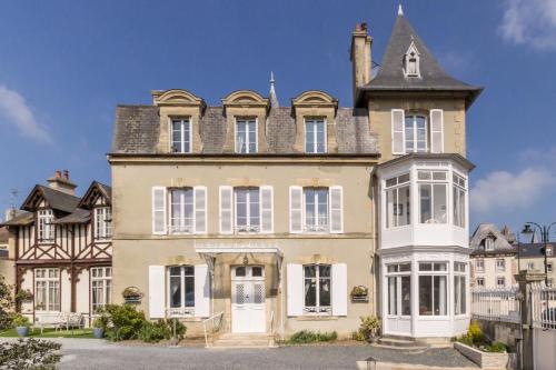 an old house with a tower on top of it at DDay Aviators Le Manoir in Arromanches-les-Bains