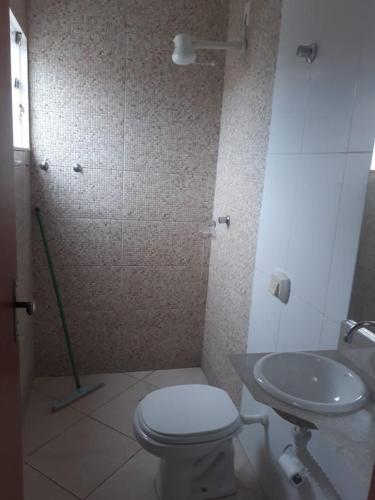 a bathroom with a toilet and a sink at CITY HOTEL in Várzea Grande