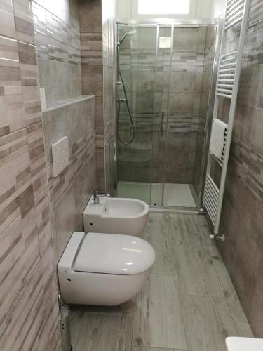 a bathroom with a toilet and a shower at Ca' da Berabusch in Gravedona
