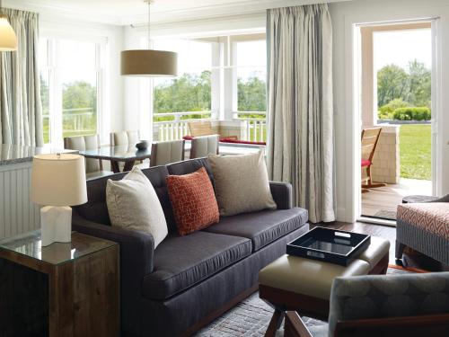 a living room with a couch and a table at Inn By the Sea in Cape Elizabeth
