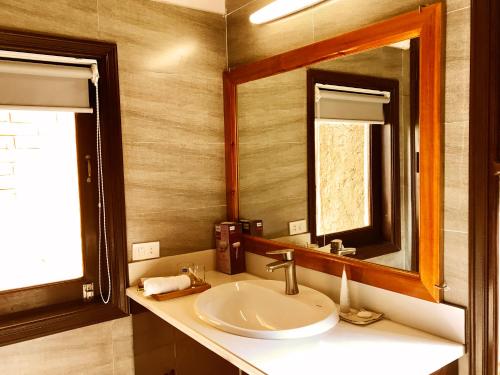 a bathroom with a sink and a mirror at May Homestay - Tam Coc Local Village in Ninh Binh