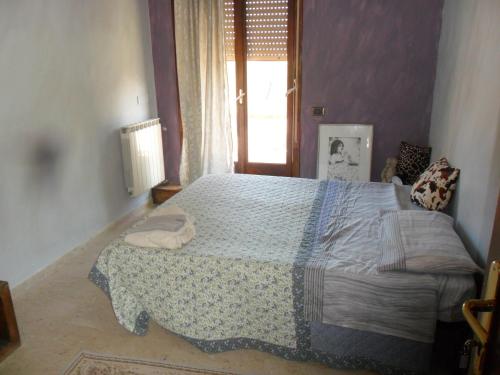 um quarto com uma cama grande num quarto com uma janela em B&B PinkHouse em Milazzo