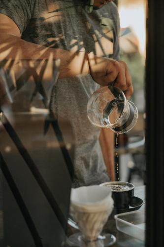 a man drinking from a wine glass at Murals Hostel and Cafe in Cebu City