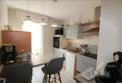 - une cuisine avec une table et deux chaises dans l'établissement La Première Etoile, à Gérardmer