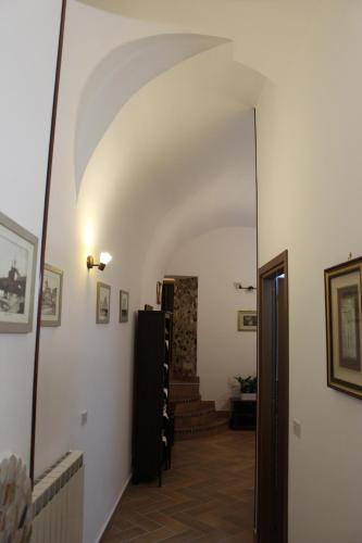 a hallway with an archway and stairs in a building at Residenza Orsini in Benevento