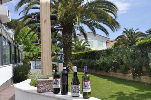 a group of bottles of wine sitting on a table at Hotel Tarabella in Forte dei Marmi