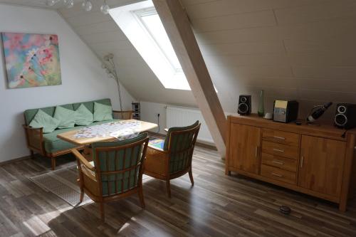 a dining room with a table and chairs and a window at Fewo Jule in Thaleischweiler-Fröschen