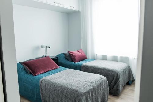 Postel nebo postele na pokoji v ubytování Forenom Serviced Apartments Vantaa Neilikkatie