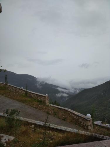 a stone wall with a view of a mountain at Elova in Zátouna