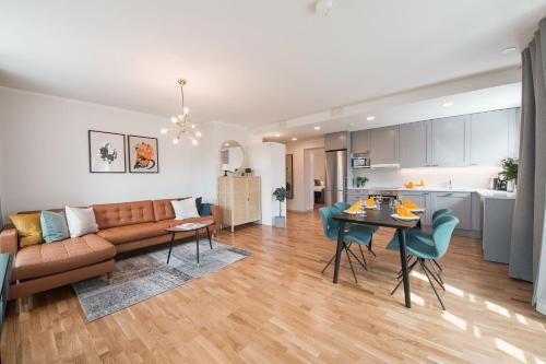 a living room and kitchen with a couch and a table at Forenom Serviced Apartments Helsinki Töölö in Helsinki