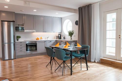 a kitchen and dining room with a table and chairs at Forenom Serviced Apartments Helsinki Töölö in Helsinki