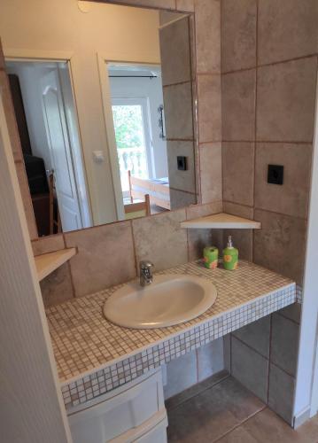 a bathroom counter with a sink and a mirror at VILLA PUNTA BLAVA - beach front, ideal for kids, large terraces with sea view, internet, Netflix, no pets allowed, 3Kw EV ch in Obrovac