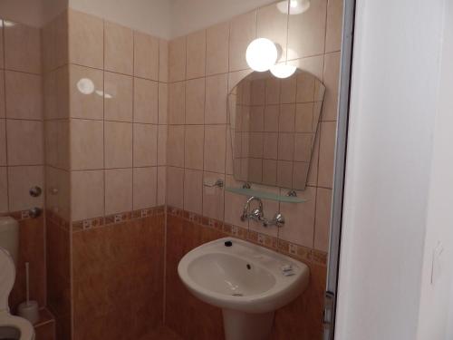 a bathroom with a sink and a mirror at Tony Guest House in Sozopol