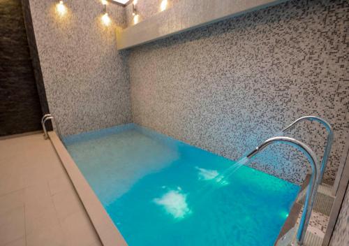 a large blue tub in a bathroom with lights at qp Hotels Trujillo in Trujillo