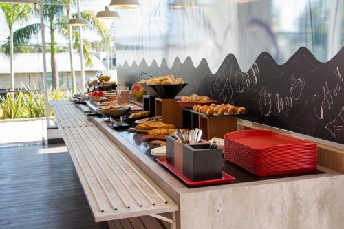 a buffet line with pastries and other food at ibis Itatiba in Itatiba