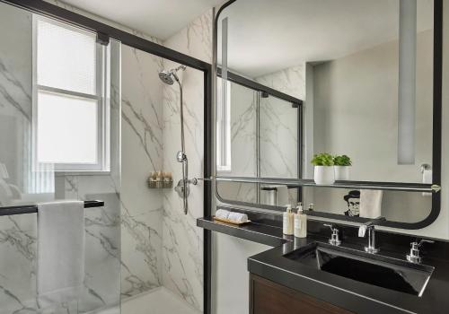 a bathroom with a sink and a shower at Hotel Emblem San Francisco in San Francisco