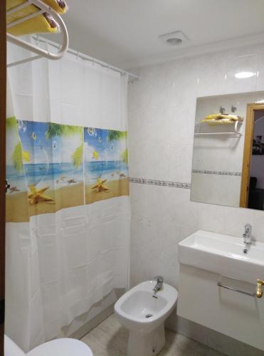 a bathroom with a toilet and a sink at Mediterranean Bliss 317 in Cala de Finestrat