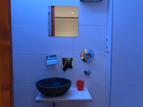 a blue bathroom with a black bowl on a table at TU Ferienzimmer in Ulm Stadtmitte in Ulm