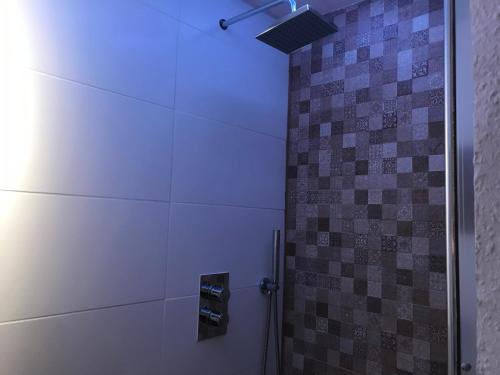 a bathroom with a shower with a blue light at TU Ferienzimmer in Ulm Stadtmitte in Ulm
