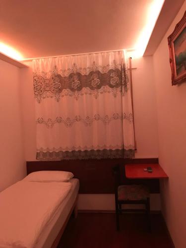 a small bedroom with a bed and a window at TU Ferienzimmer in Ulm Stadtmitte in Ulm