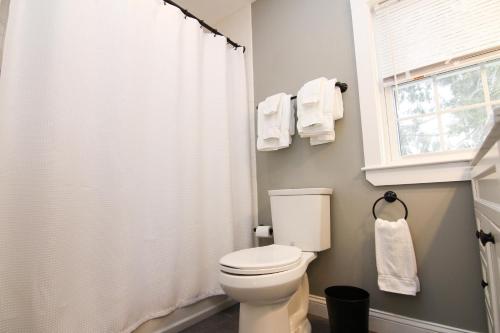 a bathroom with a white toilet and a window at Two Bedroom with Lake View in Wolfeboro