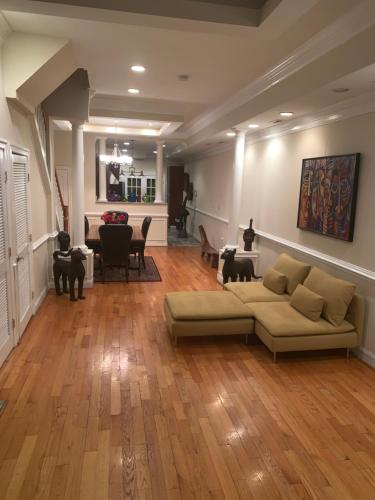 a living room with a couch and wooden floors at Bloomingdale Beauty near Union Station in Washington, D.C.