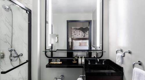 a bathroom with a mirror, sink, and toilet at Hotel Emblem San Francisco, a Viceroy Urban Retreat in San Francisco