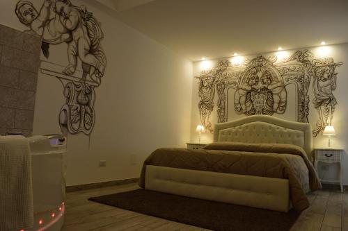 a bedroom with a bed with a horse on the wall at B&B My Sicily in Giardini Naxos