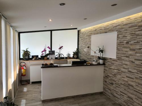 a kitchen with a counter and a brick wall at B&B My Sicily in Giardini Naxos
