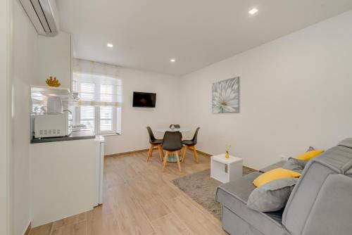 a living room with a couch and a table at Apartments Villa Tudor in Hvar