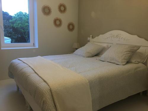 - un lit blanc dans une chambre avec fenêtre dans l'établissement gite la magnanerie, à Réauville