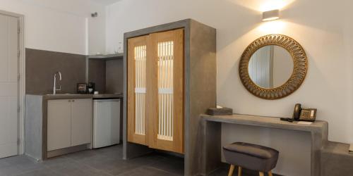a bathroom with a sink and a mirror on the wall at Elitoz Suites in Oia