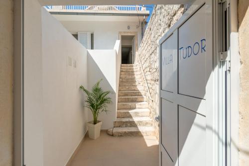 a hallway of a house with stairs and a door at Apartments Villa Tudor in Hvar