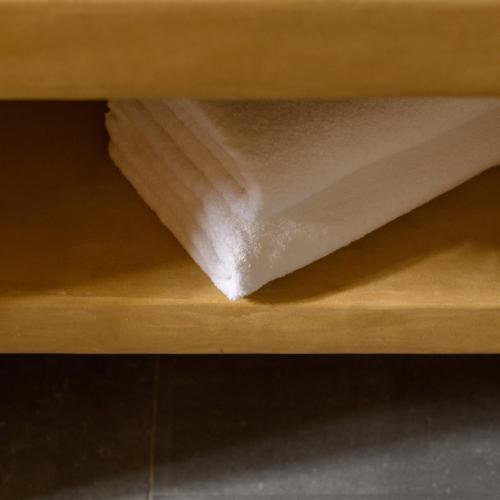a piece of white paper on a wooden shelf at Elitoz Suites in Oia