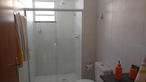 a bathroom with a shower with a glass door at Condomínio Residencial Sossego na Beira do Rio in Paulo Afonso