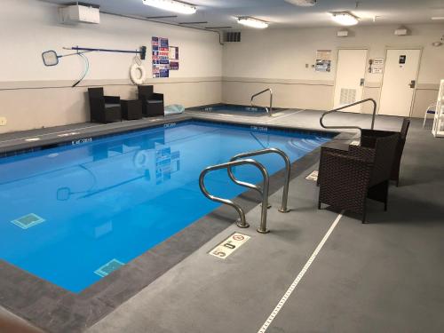 a swimming pool with blue water in a room at SureStay Plus Hotel by Best Western Vernal in Vernal