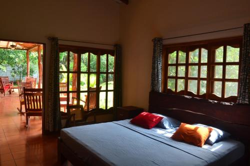 a bedroom with a bed with two pillows on it at Los Cocos, Chinandega in Chinandega