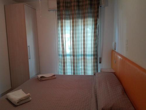 a bedroom with a bed with two towels on it at New Prophet Appartamenti in Cattolica